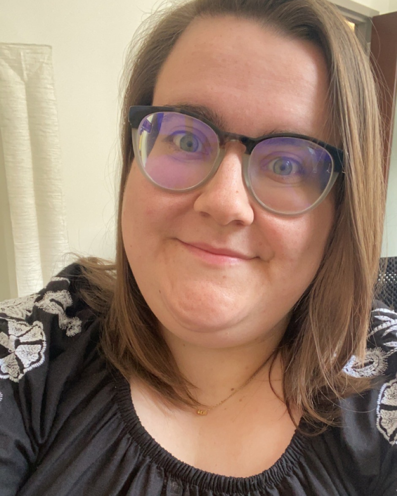 A woman with brown hair and glasses A woman with brown hair and glasses